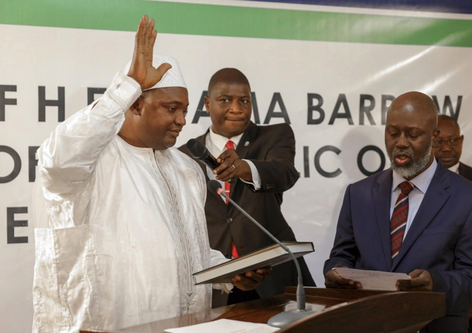 FILE - In this file photo dated Thursday, Jan 19, 2017, Adama Barrow, left, is sworn in as President of Gambia at Gambia's embassy in Dakar, Senegal. Gambia's new President Adama Barrow will return home Thursday Jan 26, 2017, after a political crisis that sent its longtime leader into exile. (AP Photo/FILE)