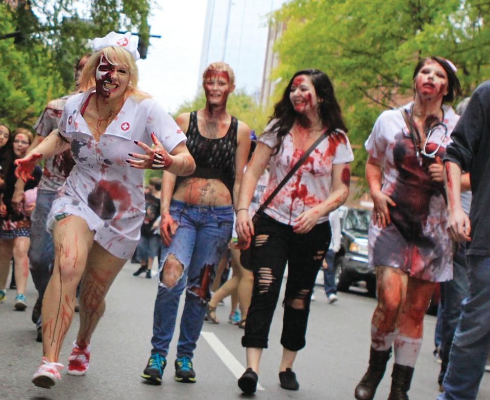 Zombies search for brains along Second Avenue downtown on Saturday during the Nashville Zombie Walk. The undead masses braved the on-again, off-again rain to come out in support of Second Harvest Food Bank of Middle Tennessee.