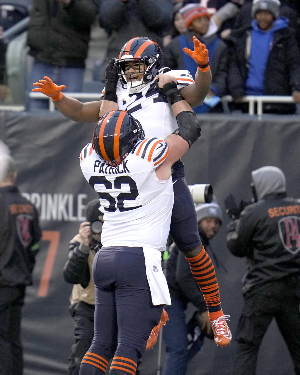 Chicago Bears guard Lucas Patrick lifts running back Khalil Herbert in the air after Herbert's touchdown during the first half of an NFL football game against the Arizona Cardinals Sunday, Dec. 24, 2023, in Chicago. (AP Photo/Erin Hooley)