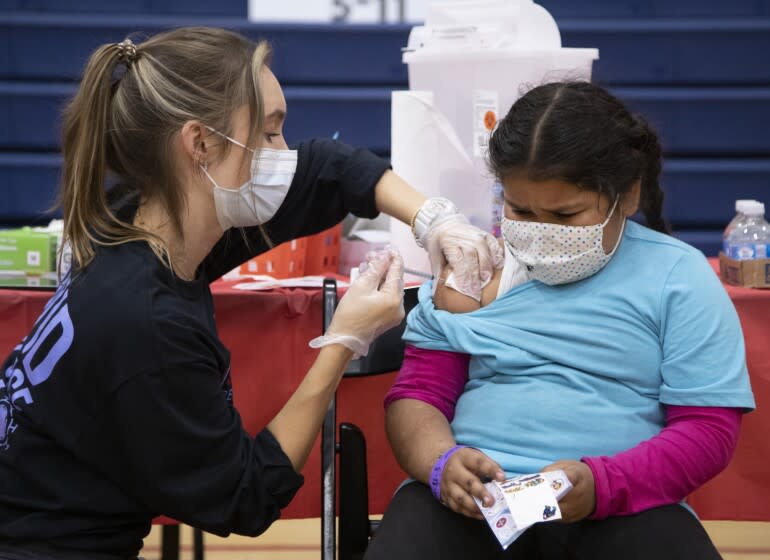 ARLETA, CA - NOVEMBER 08: Sarginoor Kaur (cq), 7, gets the COVID-19 vaccine from nurse Chelsea Meyer at Arleta High School on Monday, Nov. 8, 2021. Following the recent Centers for Disease Control and Prevention's approval of Pfizer's COVID-19 vaccine for children ages 5 to 11, Los Angeles Unified will offer voluntary vaccine access to students. The district highly encourages the vaccine for children ages 5 to 11, however, it will not be part of Los Angeles Unified's current student vaccine requirement. (Myung J. Chun / Los Angeles Times)