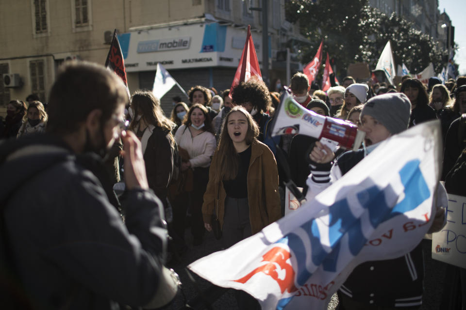 Students chants during a demonstration in Marseille, southern France, Tuesday Jan. 26, 2021. Teachers and university students marched together in protests or went on strike Tuesday around France to demand more government support amid the pandemic. (AP Photo/Daniel Cole)