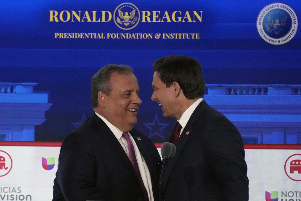 Former New Jersey Gov. Chris Christie, left, jokes with Florida Gov. Ron DeSantis during a Republican presidential primary debate hosted by FOX Business Network and Univision, Wednesday, Sept. 27, 2023, at the Ronald Reagan Presidential Library in Simi Valley, Calif. (AP Photo/Mark J. Terrill)