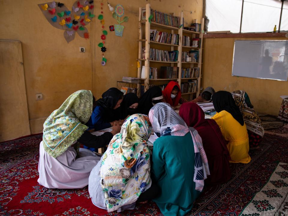 Girls cover their faces as they attend a secret school in Afghanistan.