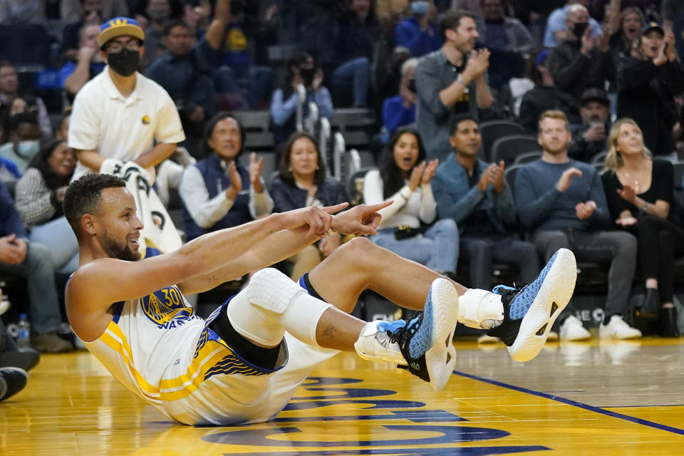 Golden State Warriors guard Stephen Curry celebrates after scoring against the Memphis Grizzlies during the first half of an NBA basketball game in San Francisco, Thursday, Oct. 28, 2021. (AP Photo/Jeff Chiu)