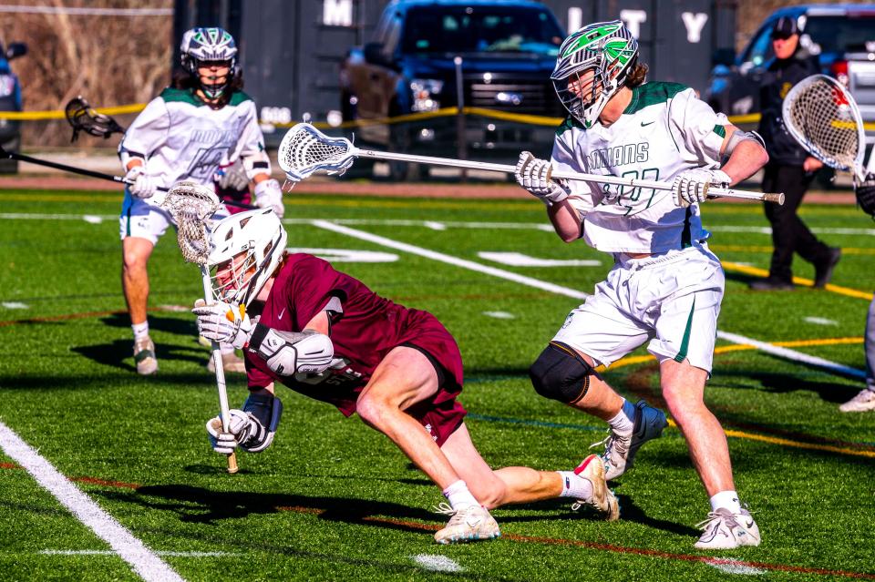 Bishop Stang's John Goll gets tripped up from behind by Dartmouth's Eli Johnson.