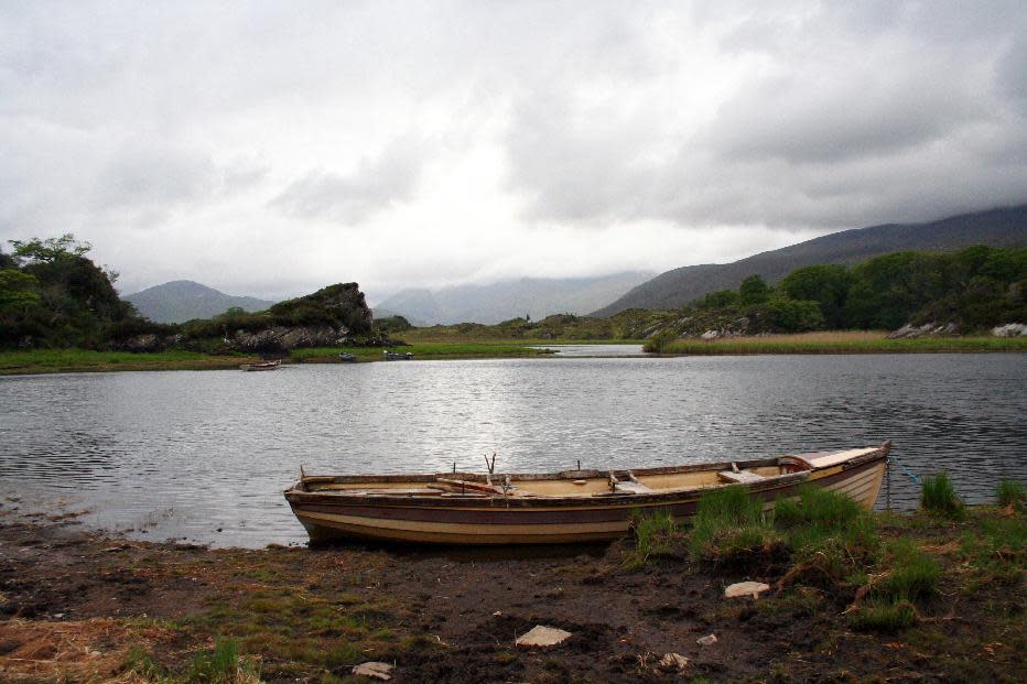 This May 28, 2012 photo shows a boat tied up on the shore of Muckross Lake in Killarney National Park, County Kerry, Ireland. Ireland is about 300 miles from north to south and a driving trip in the country's western region takes you along hilly, narrow roads with spectacular views ranging from seaside cliffs to verdant farmland. (AP Photo/Jake Coyle)