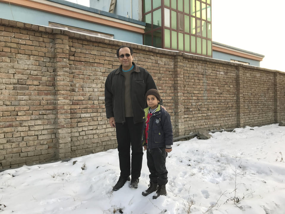 This photo provided by Bahaudin Mujtaba shows Noman Mujtaba, left, and Bahaudin Mujtaba in Kabul, Afghanistan, on Dec. 21, 2017. The boy, now 10 years old, is a distant relative of Mujtaba, who lives in Florida and is trying to adopt him and bring him to the United States. (Courtesy of Bahaudin Mujtaba via AP)