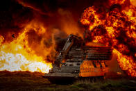 A Trojan armoured vehicle, operated by Royal Engineers, pushes forward to breach enemy positions during a simulated exercise on Salisbury Plain (Picture: UK MOD/Crown 2019)