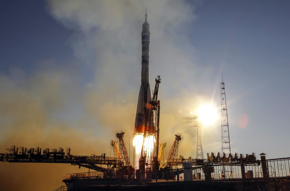 The Soyuz TMA-11M spacecraft decorated with the 2014 Sochi Winter Olympic Games logo and a blue-and-white snowflake pattern, blasts off from the launch pad at the Baikonur cosmodrome