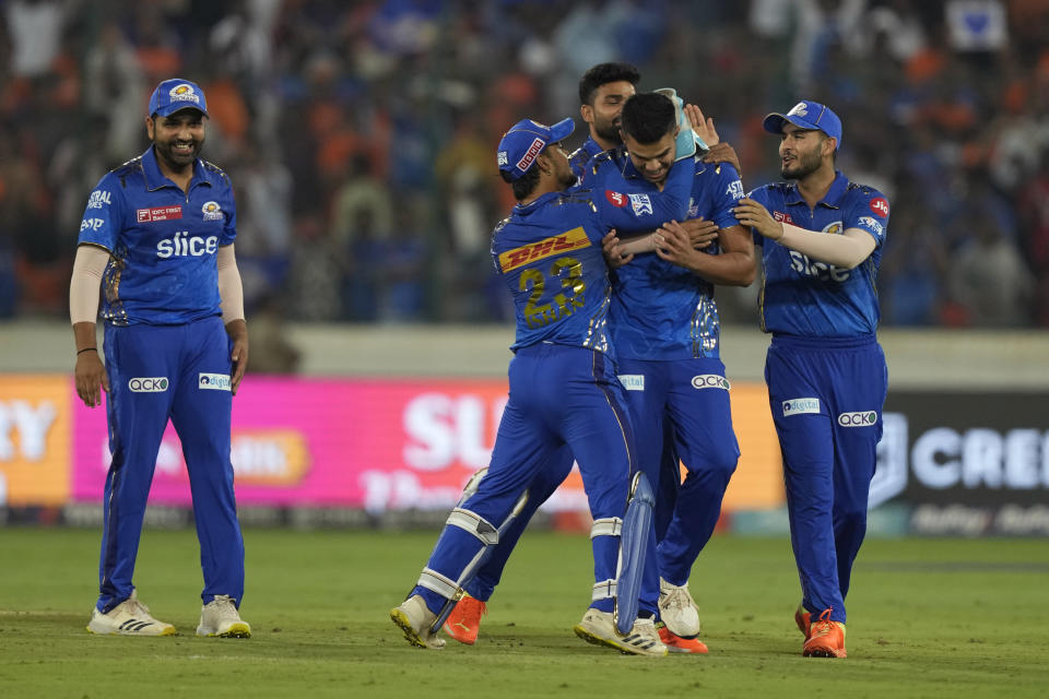 Mumbai Indians' Arjun Tendulkar is congratulated by teammates as Mumbai Indians' players celebrate their victory over Sunrisers Hyderabad during their Indian Premier League cricket match in Hyderabad, India, Tuesday, April 18, 2023. (AP Photo/Mahesh Kumar A.)