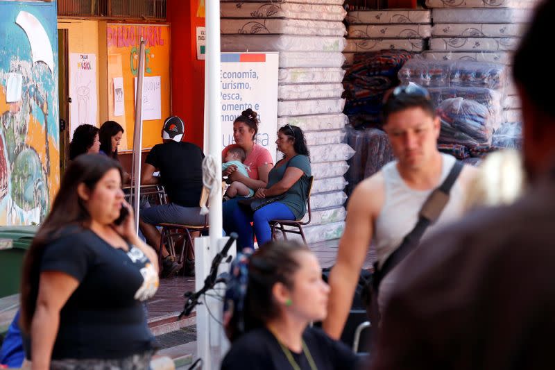 Victims are seen inside a shelter, after losing their homes in a fire, following the spread of wildfires in Valparaiso