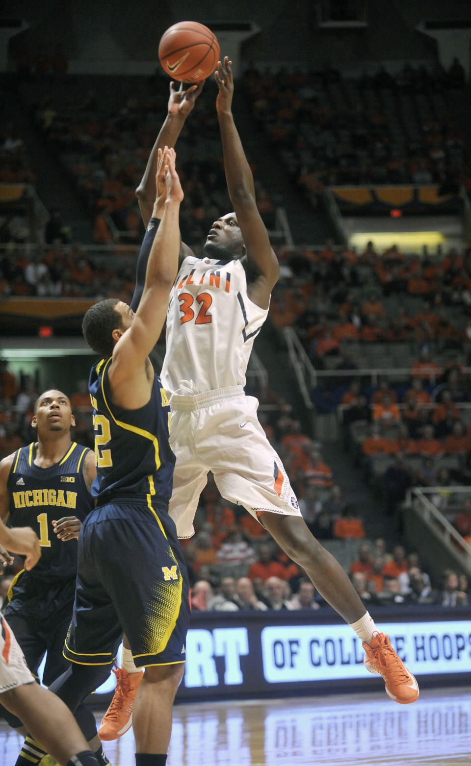 Illinois' Nnanna Egwu (32) shoots over Michigan forward Jordan Morgan (52) during the first half of an NCAA college basketball game Tuesday, March 4, 2014, in Champaign, Ill. (AP Photo/Rick Danzl)