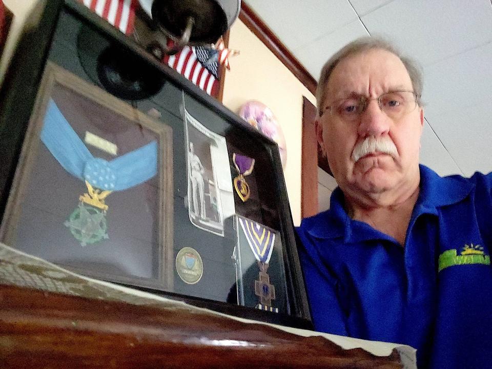 John Edwards of Plainville, Mass., holds a shadow box containing medals awarded to his uncle, Cumberland native Lt. Robert Waugh, for his service in World War II. The Medal of Honor is at left, and the Rhode Island Cross is at bottom right.