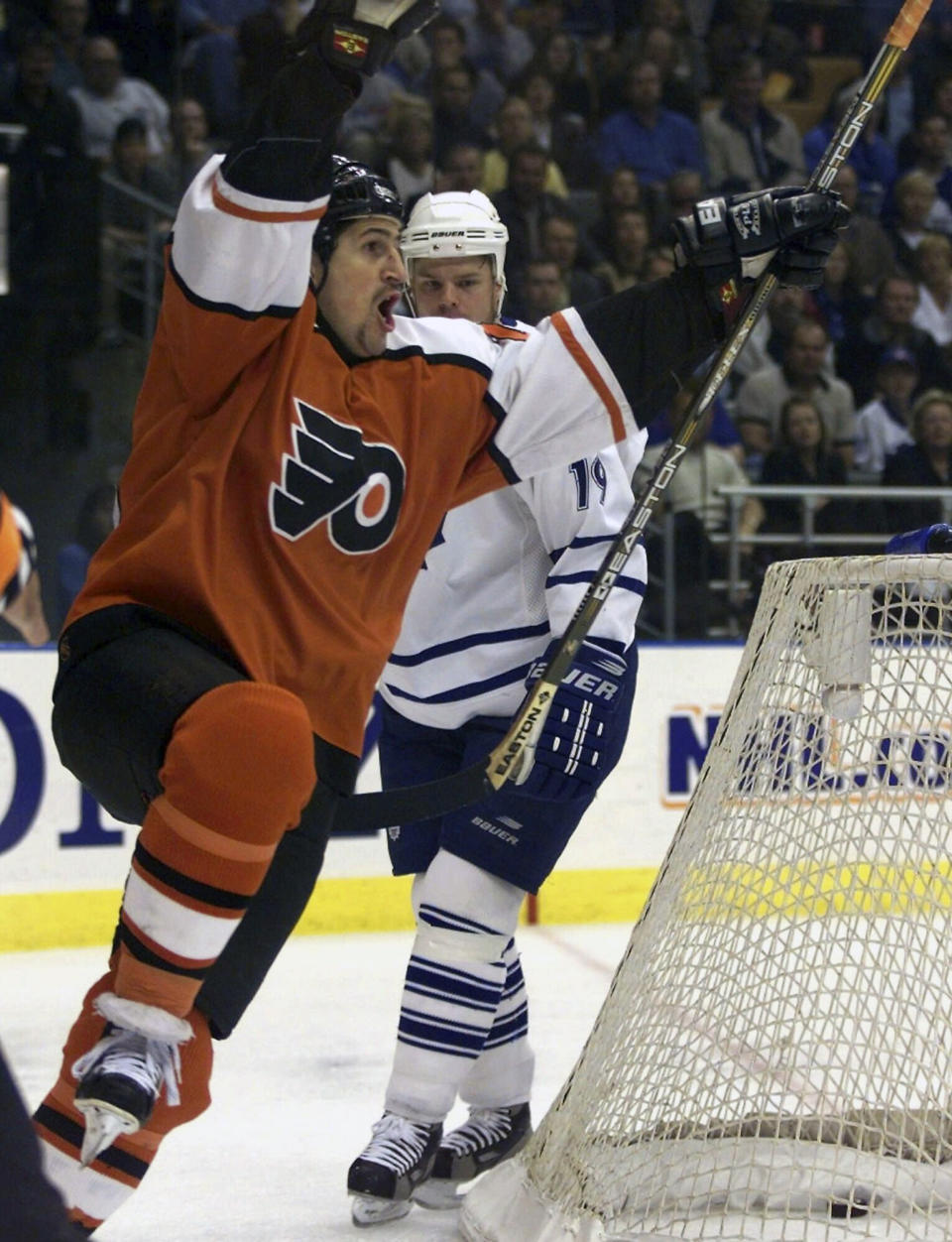 FILE - Philadelphia Flyers right winger Keith Jones, left, celebrates his goal as Toronto Maple Leafs left winger Fredrik Modin looks at the puck in the back of the net during first period of an NHL hockey game in Toronto, Friday, April 30, 1999. Keith Jones played for the Flyers from 1998-2001. The Flyers have named long-time television analyst Keith Jones team president of hockey operations and have removed the interim tag from general manager Danny Briere's title. Jones was a surprise choice Thursday, May 11, 2023, after he spent the last 23 years as an analyst for Flyers telecasts on NBC Sports Philadelphia.(AP Photo/Frank Gunn, File)