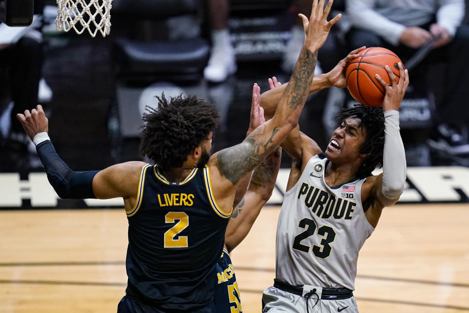 Purdue guard Jaden Ivey (23) shoots over Michigan forward Isaiah Livers (2) during the second half of an NCAA college basketball game in West Lafayette, Ind., Friday, Jan. 22, 2021. (AP Photo/Michael Conroy)