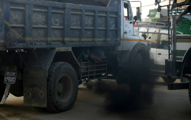 A truck belches out black smoke on a road in Kathmandu