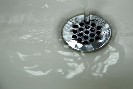 Running tap water is seen in Flint, a city struggling with the effects of lead-poisoned drinking water, Michigan May 4, 2016. REUTERS/Carlos Barria