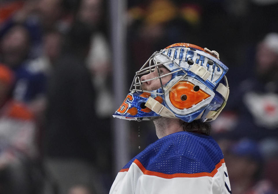 Edmonton Oilers goalie Jack Campbell watches the replay after allowing a aoal to the Vancouver Canucks during the second period of an NHL hockey game Wednesday, Oct. 11, 2023, in Vancouver, British Columbia. (Darryl Dyck/The Canadian Press via AP)