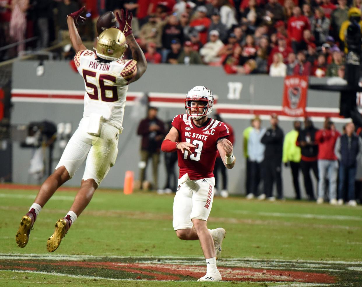 Oct 8, 2022; Raleigh, North Carolina, USA; Florida State Seminoles defensive lineman Patrick Payton (56) blocks the pass of North Carolina State Wolfpack quarterback Devin Leary (13) during the first half at Carter-Finley Stadium. Mandatory Credit: Rob Kinnan-USA TODAY Sports