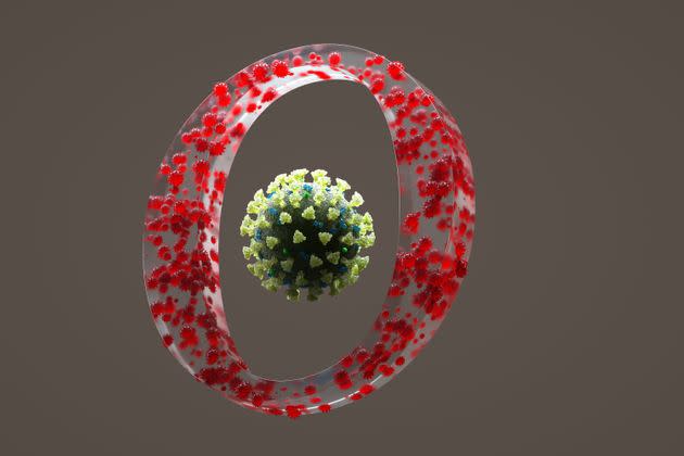 Digital generated image of COVID-19 cells organised into circular shape and made OMICRON sign with one big mutated virus cell on the middle against beige background. (Photo: Andriy Onufriyenko via Getty Images)