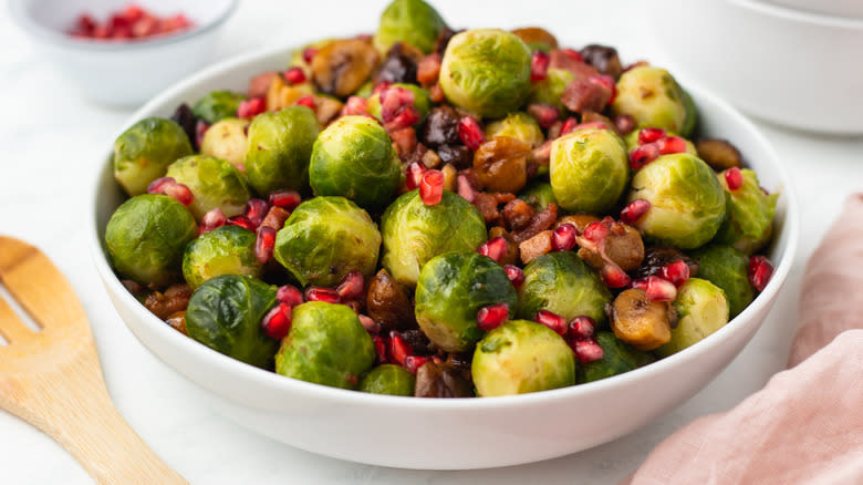 Bacon chestnut pomegranate sprouts in white bowl