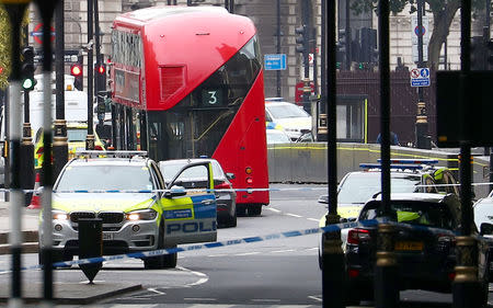 A car that crashed outside the Houses of Parliament is surrounded by members of the emergency services in Westminster, London, Britain, August 14, 2018. REUTERS/Hannah McKay