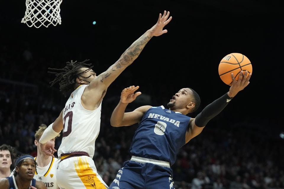 Nevada's Hunter McIntosh (0) shoots against Arizona State's Frankie Collins (10) during the first half of a First Four college basketball game in the NCAA men's basketball tournament, Wednesday, March 15, 2023, in Dayton, Ohio. (AP Photo/Darron Cummings)