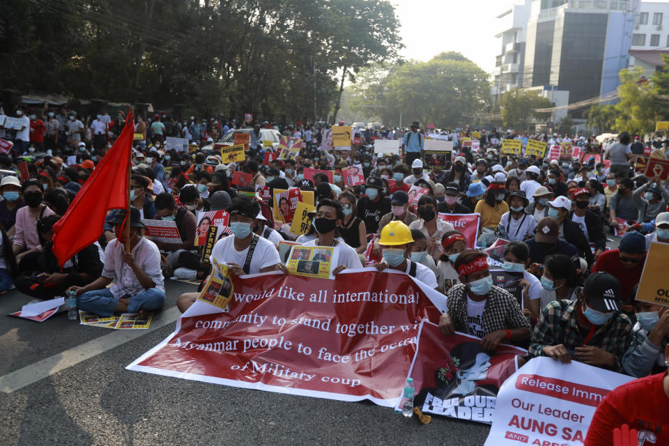 Anti-coup protesters gather near the headquarters of the National League for Democracy party in Yangon, Myanmar Monday, Feb. 15, 2021. Security forces in Myanmar intensified their crackdown against anti-coup protesters on Monday, seeking to quell the large-scale demonstrations calling for the military junta that seized power earlier this month to reinstate the elected government. (AP Photo)