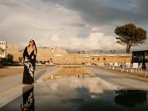 A woman stands beside the pool at the Mamula Island Hotel.