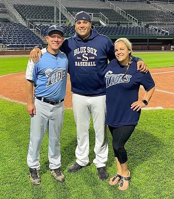Former Boston Red Sox pitcher Manny Delcarmen, center, pitched one inning last year during the Northeast Tides’ benefit doubleheader in Portland, Maine, at Hadlock Field. He is pictured with Scott and Beverly Bleakley.