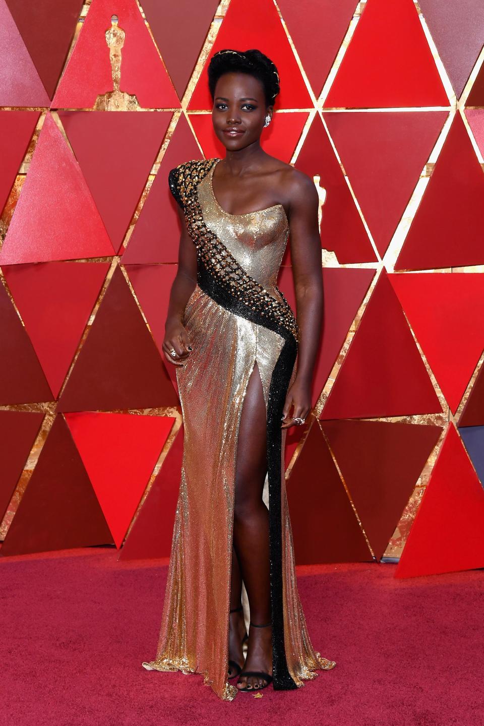 <p>Lupita Nyong'o wears a striking metallic dress designed by Atelier Versace.</p>