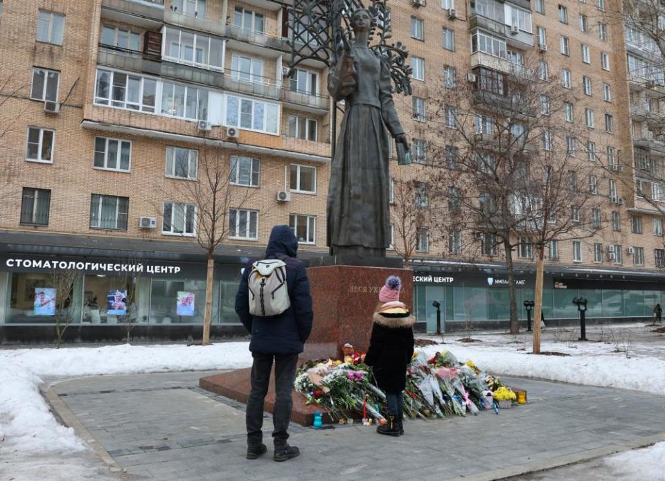 In Moscow, people lay flowers at a monument to Ukrainian poet and writer Larisa Kosach-Kvitka, known by her pen name Lesya Ukrainka, in memory of the victims of the Russian missile strike on an apartment block in Dnipro.