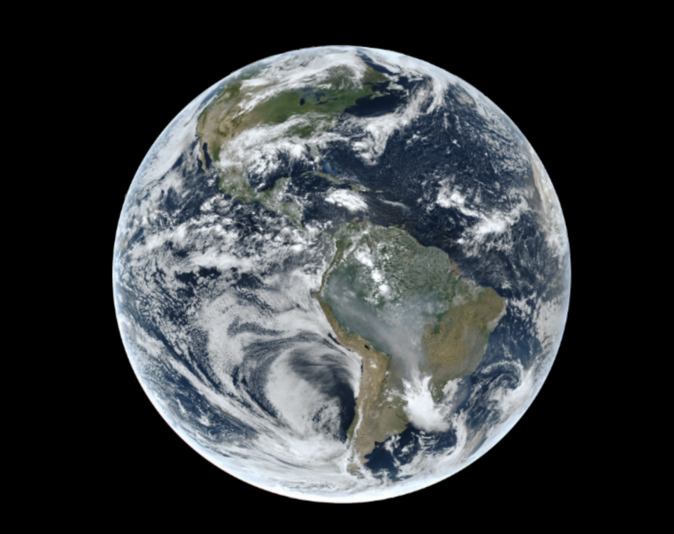 View of Earth from space showing North and South America, with visible cloud formations and weather patterns