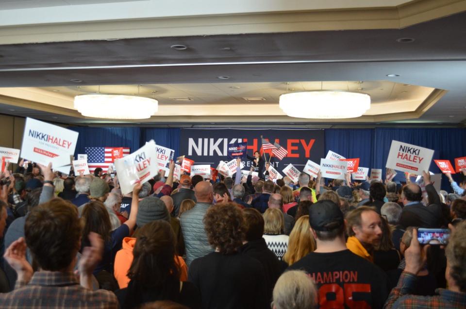 Signs wave across the crowd as Nikki Haley concludes her speech.