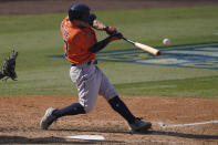 Houston Astros' Jose Altuve hits a two-run single against the Oakland Athletics during the sixth inning of Game 1 of a baseball American League Division Series in Los Angeles, Monday, Oct. 5, 2020. (AP Photo/Ashley Landis)