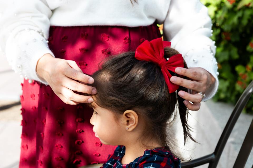 Melissa Alcivar puts a bow in her daughter Samantha Alcivar’s hair before the Saturday morning session of the 193rd Semiannual General Conference of The Church of Jesus Christ of Latter-day Saints at the Conference Center in Salt Lake City on Saturday, Sept. 30, 2023. | Megan Nielsen, Deseret News