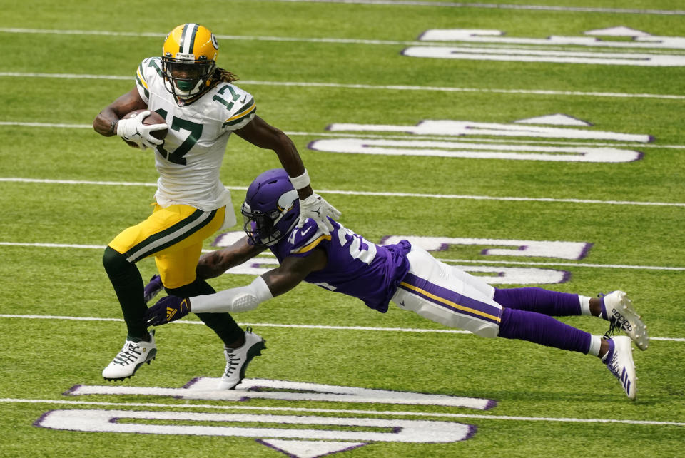 Green Bay Packers wide receiver Davante Adams breaks a tackle by Minnesota Vikings defensive back Holton Hill (24) during the first half of an NFL football game, Sunday, Sept. 13, 2020, in Minneapolis. (AP Photo/Jim Mone)