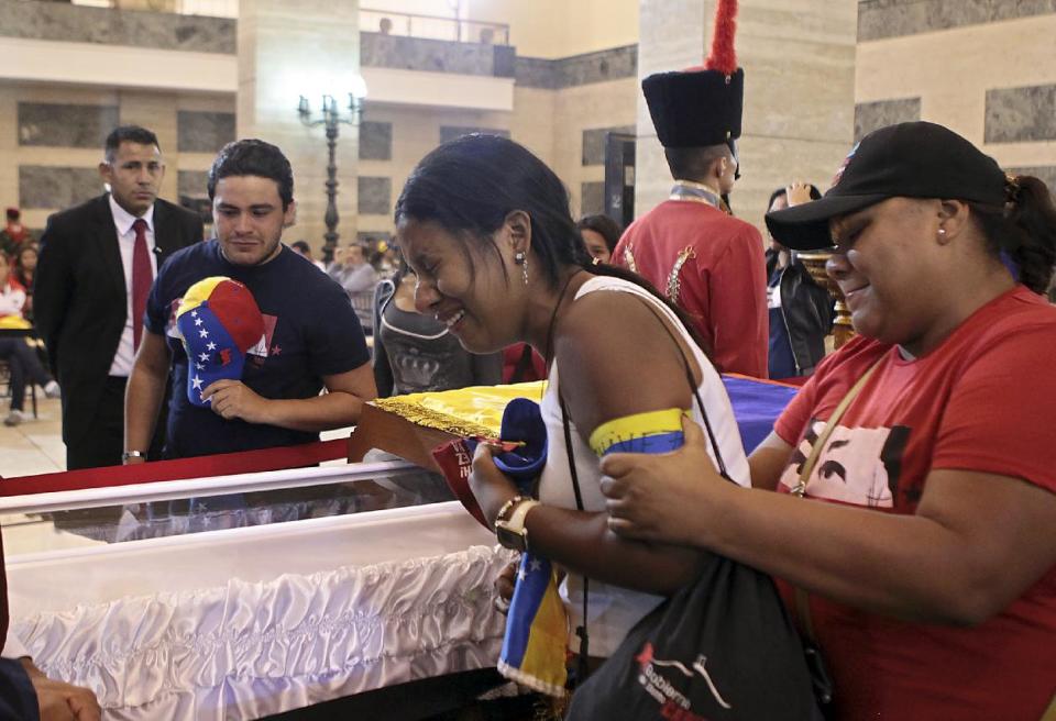 Una mujer llora con desconsuelo ante el ataúd de Hugo Chávez este 6 de marzo de 2013 en la Academia Militar de Caracas, en una imagen divulgada por la presidencia de Venezuela. Miles de venezolanos aguardaron hasta nueve horas este jueves para poder ver por última vez el rostro del fallecido presidente. Presidencia/AFP | Efraín González