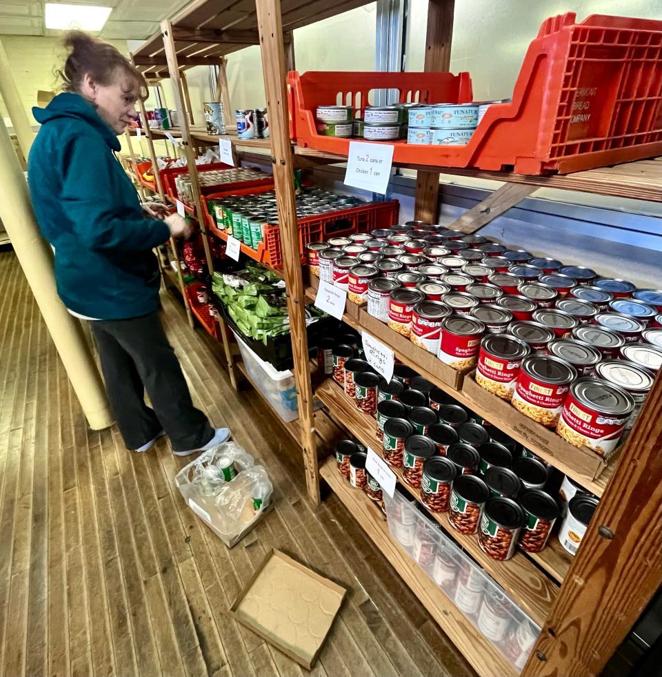 Volunteer Sheila Lynds is seen here on Saturday, March 16, 2024, checking inventory of canned goods at the Matthew Mission food pantry in Taunton.