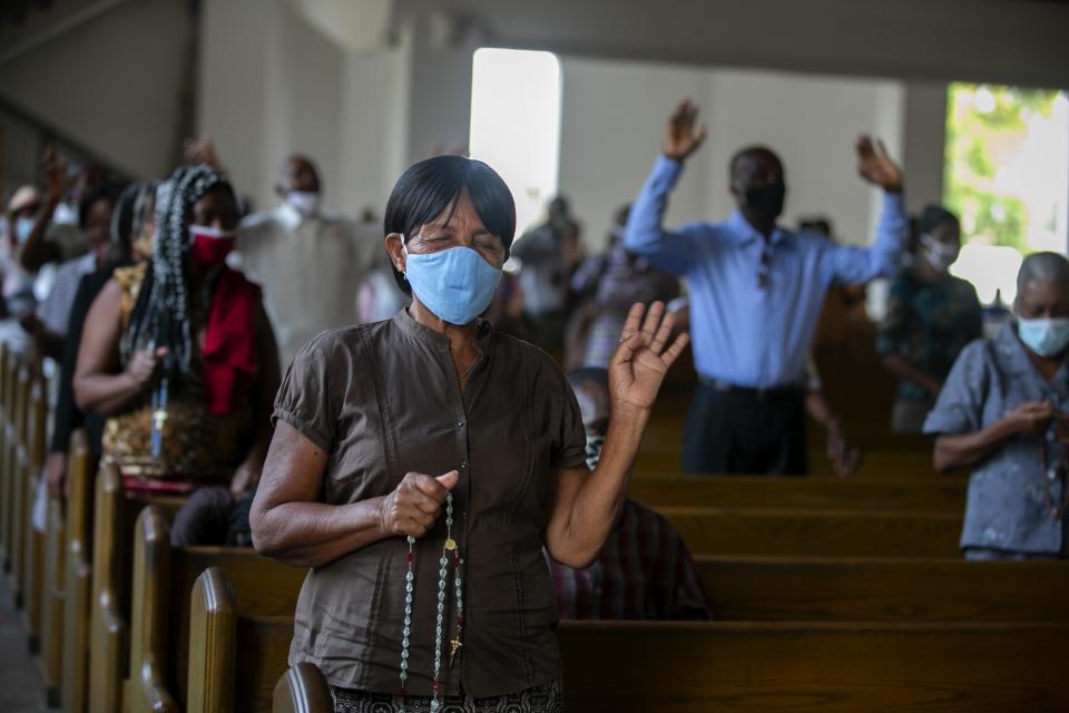 Worshipers attend a Mass at the Cathedral of Port-au-Prince, marking the reopening of places of worship since the beginning in March of the COVID-19 lockdown, in Port-au-Prince, Haiti, Sunday, July 12, 2020. By order of President Jovenel Moise and the recommendation of Haiti's health authorities, churches reopened after having been closed for months due to social distancing rules to curb the spread of the pandemic. (AP Photo/Dieu Nalio Chery)