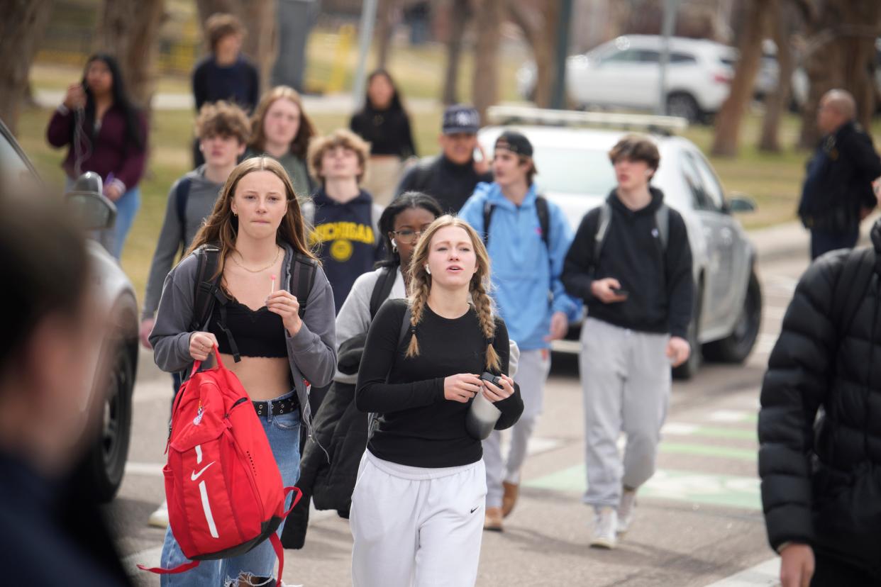 Students are walked out of East High School following a shooting, Wednesday, March 22, 2023, in Denver (AP)
