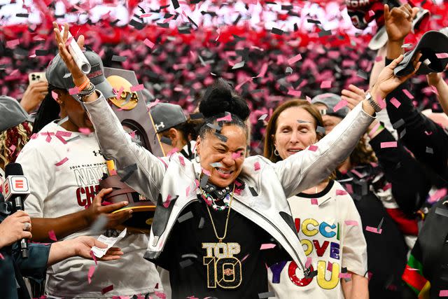 <p>Thien-An Truong/ISI Photos/Getty </p> Head coach Dawn Staley of the South Carolina Gamecocks is showered with confetti after defeating the Iowa Hawkeyes 87-75 at the 2024 NCAA Women's Basketball Tournament championship game between Iowa and South Carolina at Rocket Mortgage FieldHouse on April 7, 2024 in Cleveland, Ohio.
