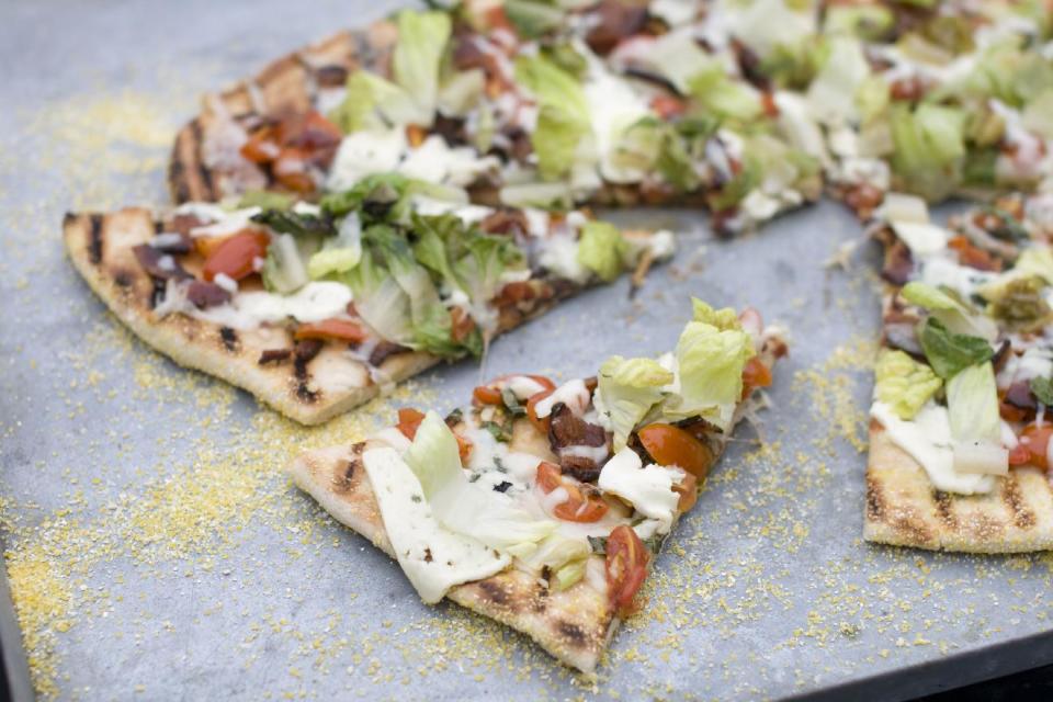 This July 22, 2013 photo taken in Concord, N.H., shows a recipe for grilled BLT pizza with summer tomato-basil sauce. (AP Photo/Matthew Mead)