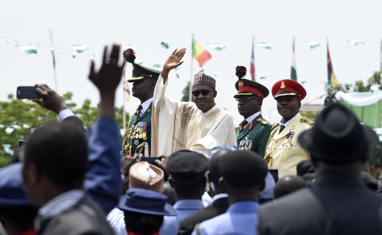 Nigerian President Muhammadu Buhari (C) waves to the crowd during his inauguration ceremony as President of Nigeria, in Eagle Square in Abuja, May 29, 2015