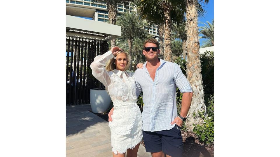 Amelia Spencer in white dress with Greg Mallett on holiday