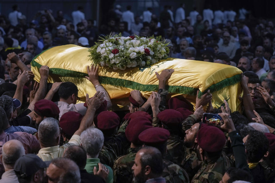 Hezbollah fighters carry the coffin of their comrade, senior commander Mohammad Naameh Nasser, who was killed by an Israeli airstrike that hit his car in the southern costal town of Tyre, during his funeral procession in the southern suburbs of Beirut, Lebanon, Thursday, July 4, 2024. (AP Photo/Bilal Hussein)