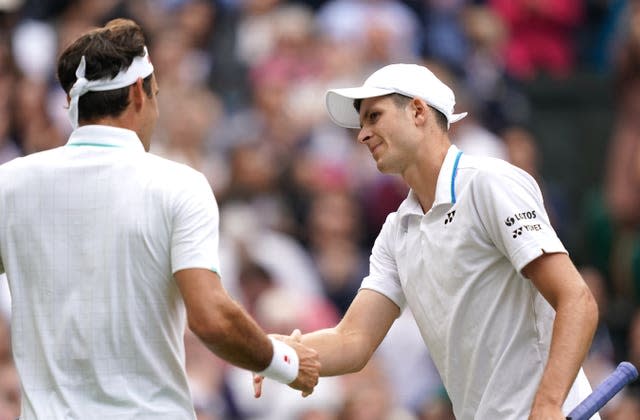 Hubert Hurkacz shakes hands with Roger Federer