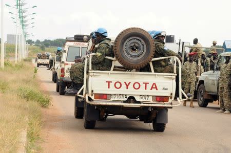 U.N. peacekeepers and South Sudan National security members ride on their truck as they protect internally displaced people during a reallocation at the United Nations Mission in South Sudan (UNMISS) compound at the UN House in Jebel, in South Sudan's capital Juba, August 31, 2016. REUTERS/Jok Solomun