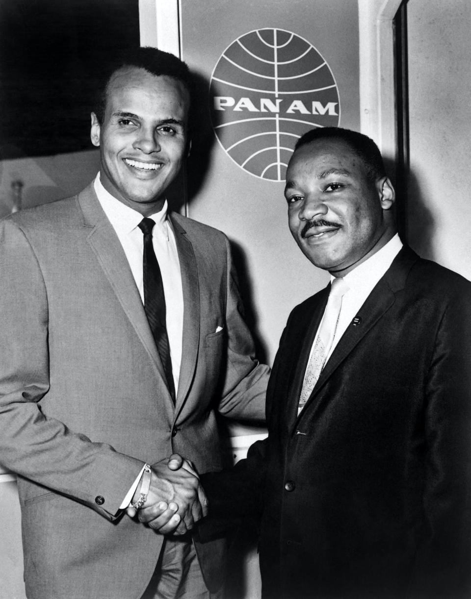 Harry Belafonte and Martin Luther King Jr. shaking hands on Aug. 21, 1964, at JFK International Airport in New York. <a href="https://www.gettyimages.com/detail/news-photo/singer-harry-belafonte-shakes-hands-with-us-clergyman-and-news-photo/494798200?adppopup=true" rel="nofollow noopener" target="_blank" data-ylk="slk:AFP via Getty Images;elm:context_link;itc:0;sec:content-canvas" class="link ">AFP via Getty Images</a>