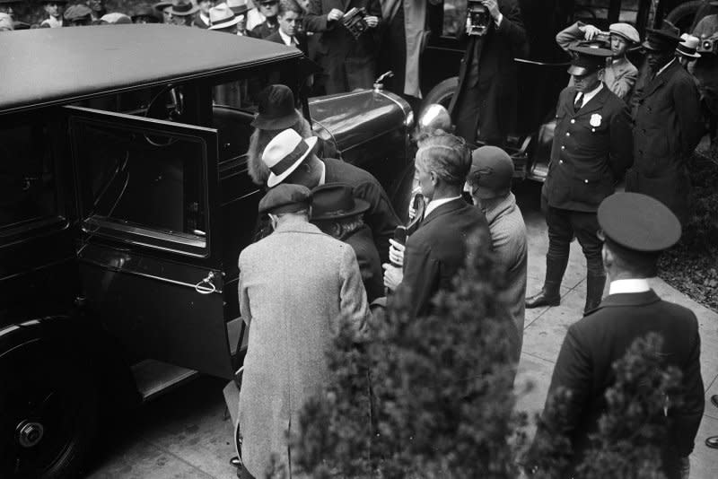 Albert B. Fall, former secretary of interior, is helped into his car as he leaves the District and Supreme Court in Washington, D.C., on October 25, 1929. Fall was found guilty of accepting a bribe of $100,000 from E.L. Doheny as part of the Teapot Dome Scandal. File Photo by Library of Congress/UPI